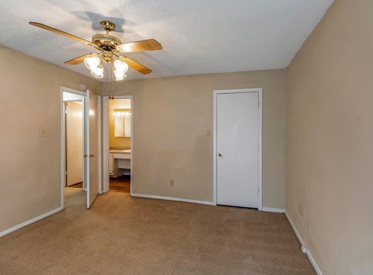 Bedroom with ceiling fan, closet, and wall to wall carpet